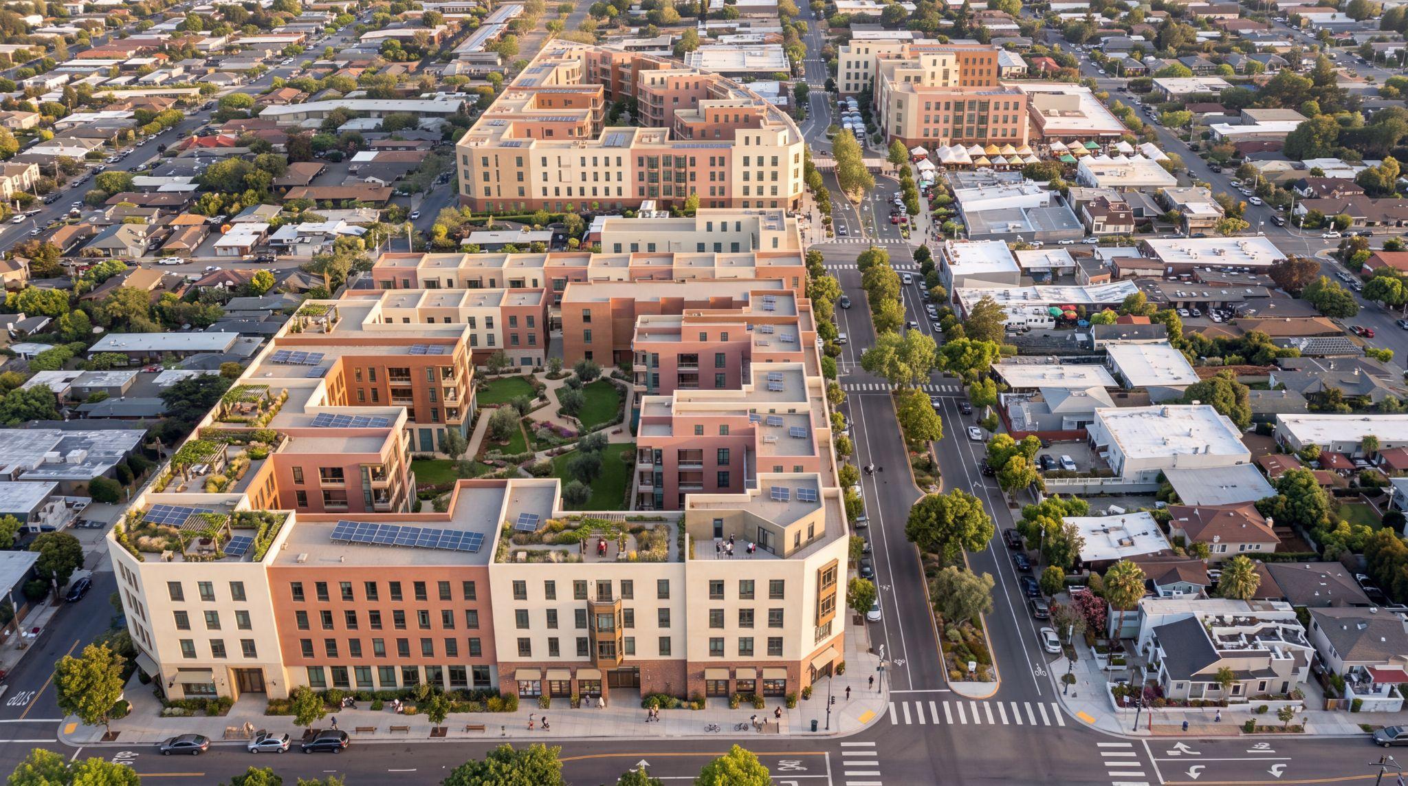 Illustrative aerial of distinct building groups around shared courtyards, with a continuous street frontage.